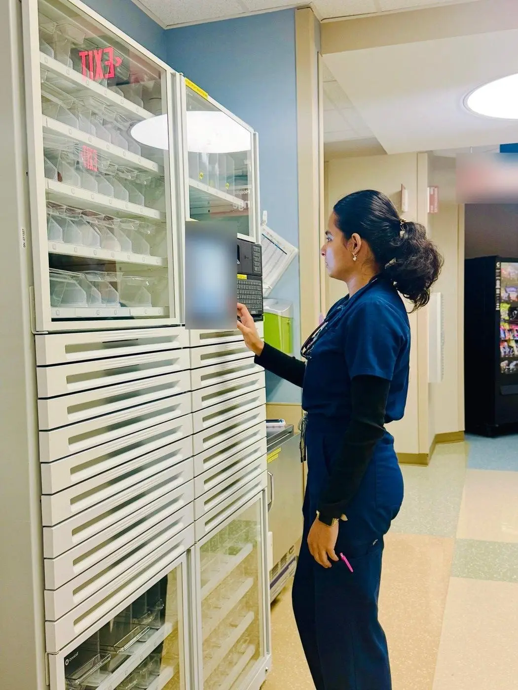 Sabina Uprety, RN, at a medication dispensing cabinet