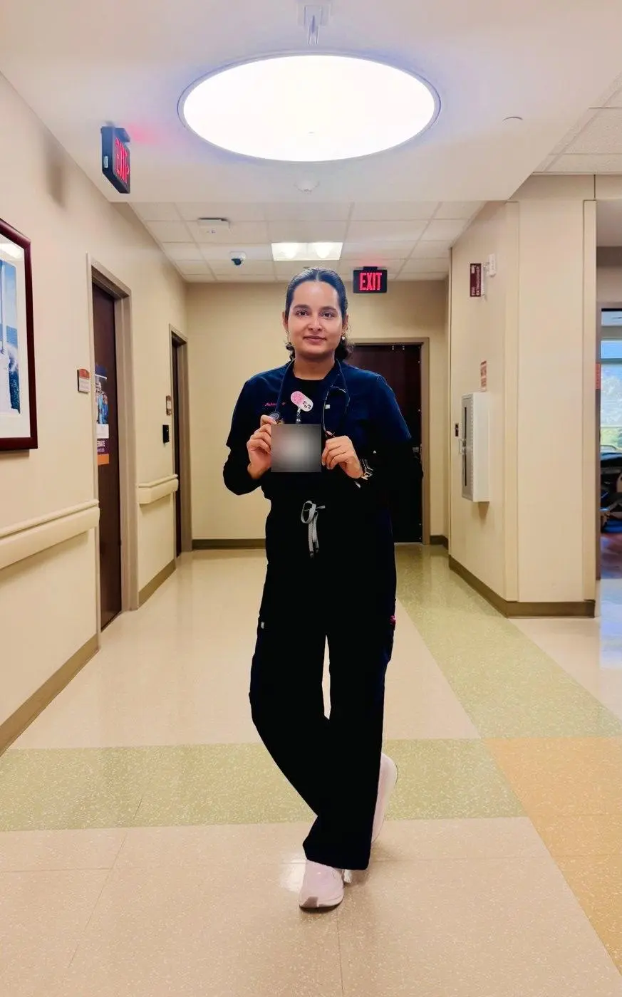 Sabina Uprety, RN, in a hospital hallway